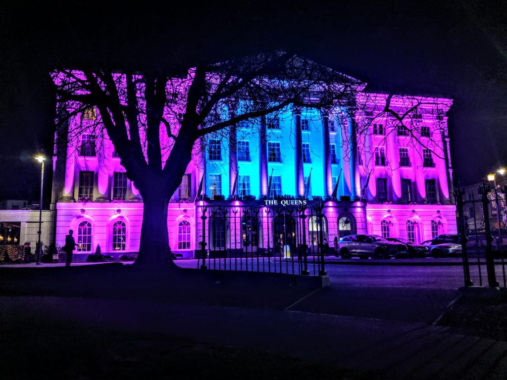 The Queens Hotel in Cheltenham lit up with blue and purple lights