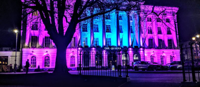 The Queens Hotel in Cheltenham lit up with blue and purple lights